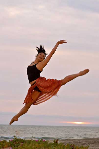 Picture of Anne, jumping at the beach.